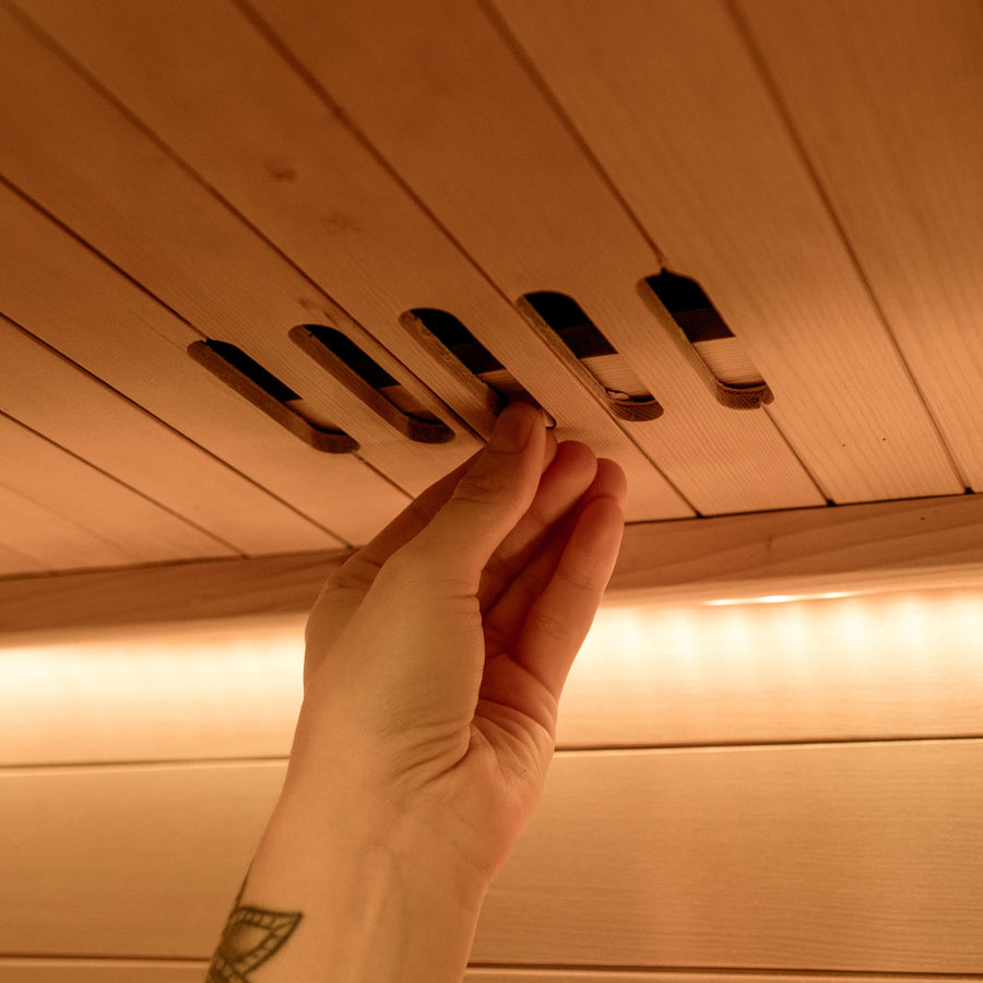 Warm ambient lighting inside the Nordik sauna at night